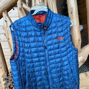 The North Face Quilted Blue Vest with Orange Logo